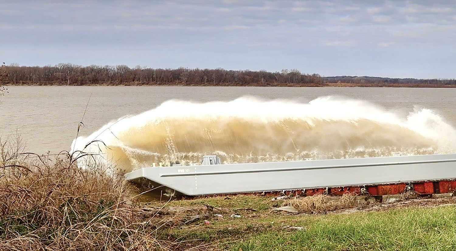 A new 150-by-60-by-9-foot barge is launched into the Ohio River on December 23. The barge is owned by Waterways Barge LLC, is built to hold heavy cranes and is available for lease. (Photo by Emma Davis)