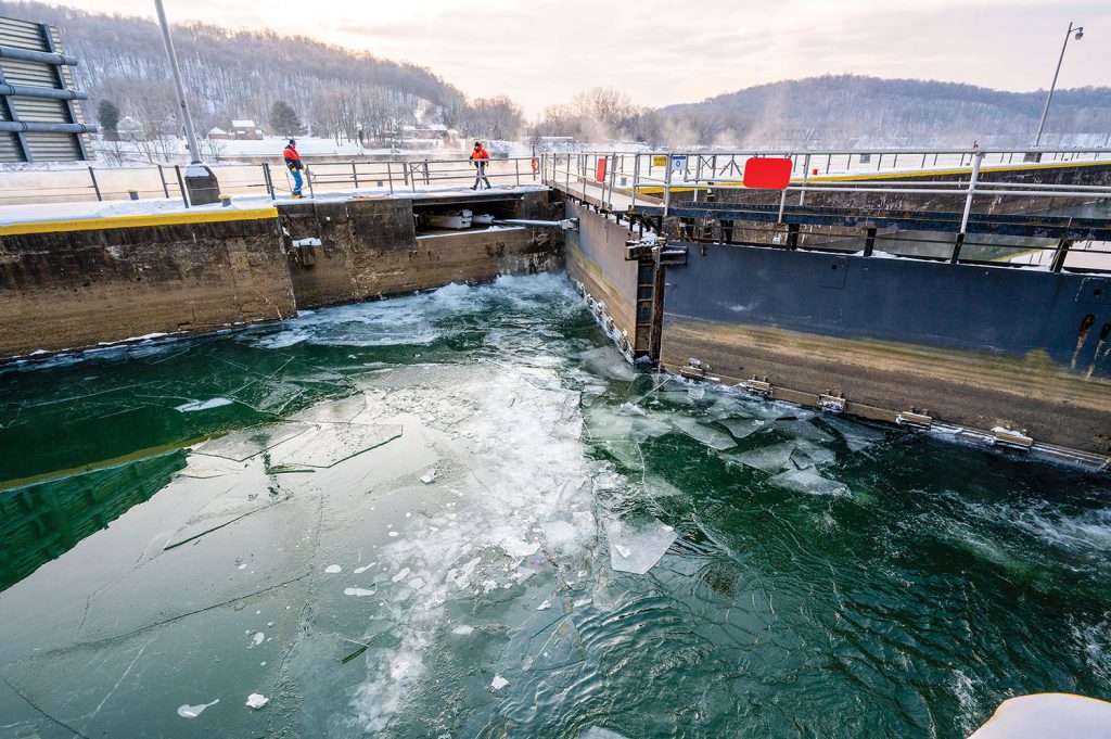 Lock operators for the Pittsburgh Engineer District break up ice in the water to float it down the chamber and clear the Allegheny River Lock and Dam 5 for navigation in Freeport, Pa., on January 26. (Photo by Michel Sauret/Pittsburgh Engineer District)