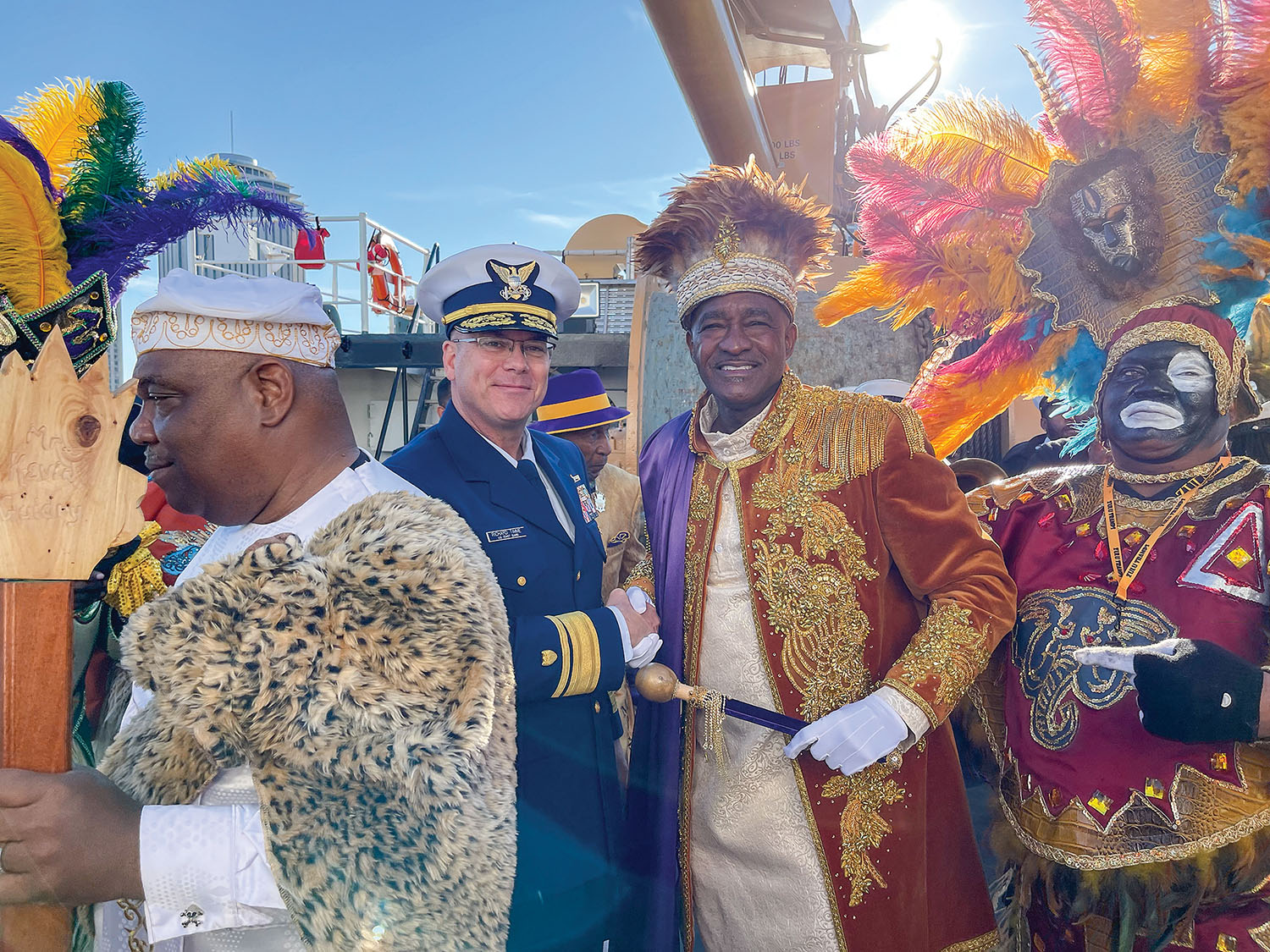 Rear Adm. Richard Timme, commander of the Eighth Coast Guard District, shakes hands with Randolph “Rudy” Davis, the 2022 King of the Zulu Social Aid and Pleasure Club, aboard the U.S. Coast Guard Cutter Barbara Mabrity on Lundi Gras, February 28, in New Orleans. (Photo by Frank McCormack)