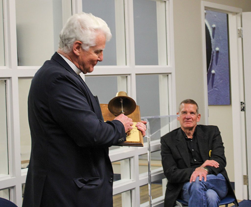 The Rev. Kempton Baldridge, outgoing SCI river chaplain, presents the Rev. David Shirk, the new river chaplain, with a bell. It was one of several “tools of the trade” with which Baldridge presented Shirk in a ceremony February 28 at the Seamen’s Church Institute’s Center for Maritime Education in Paducah, Ky. (Photo by Shelley Byrne)