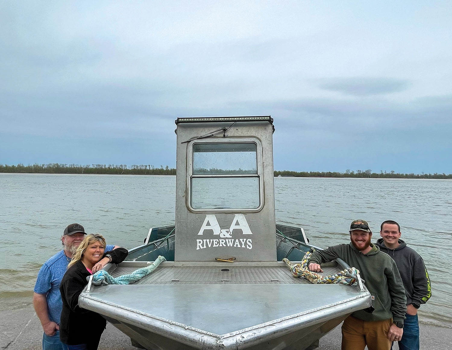 Left to right: Richie and Starla Neal with sons Andrew and Aaron Neal. Richie founded the grocery and supply delivery business, which Andrew now runs with continued help from many family members. (Photo courtesy of A&A Riverways)