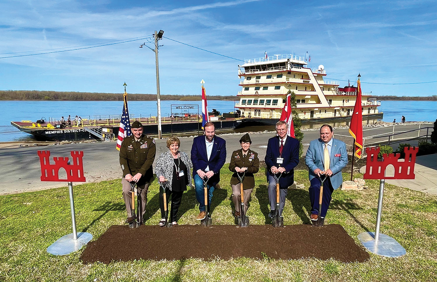 With the mv. Mississippi in the background, federal, state and local officials break ground for a new project to replace the Caruthersville floodwall. (Photo courtesy of Memphis Engineer District)