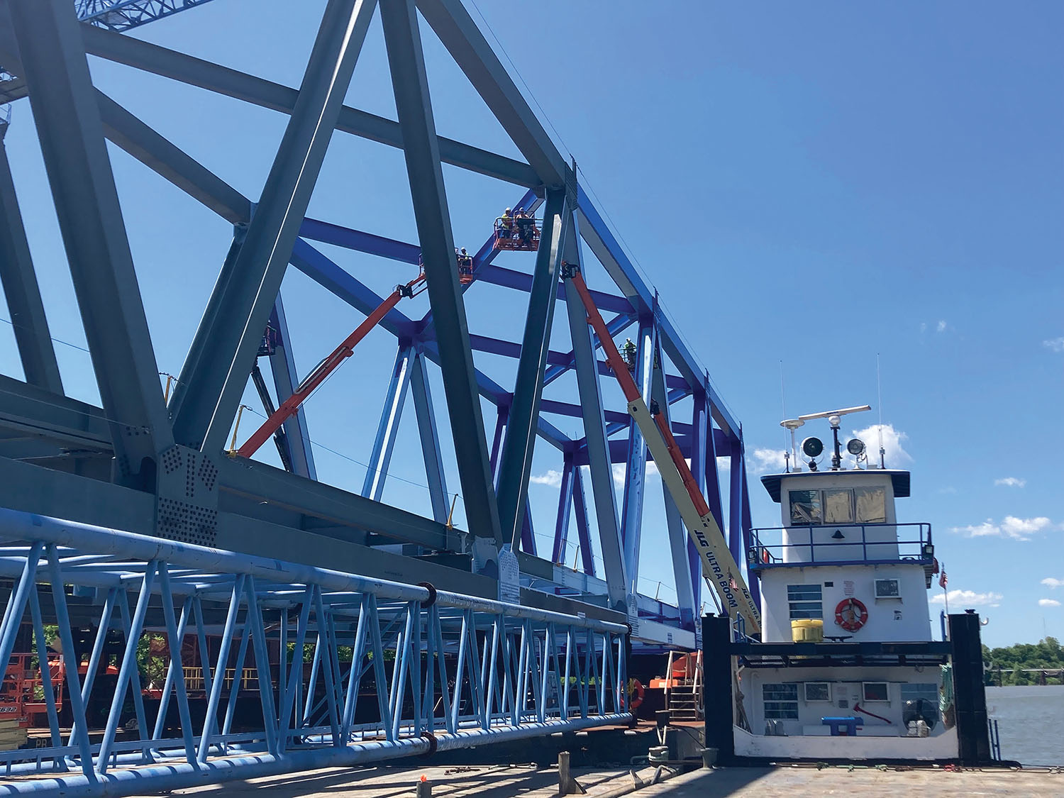 Assembly of the 700-foot steel truss for the main span of the new Cumberland River Bridge at Smithland, Ky., was completed in late February, and painting is now 30-40 percent completed. (Photo by Martina Britts, American Bridge Company)
