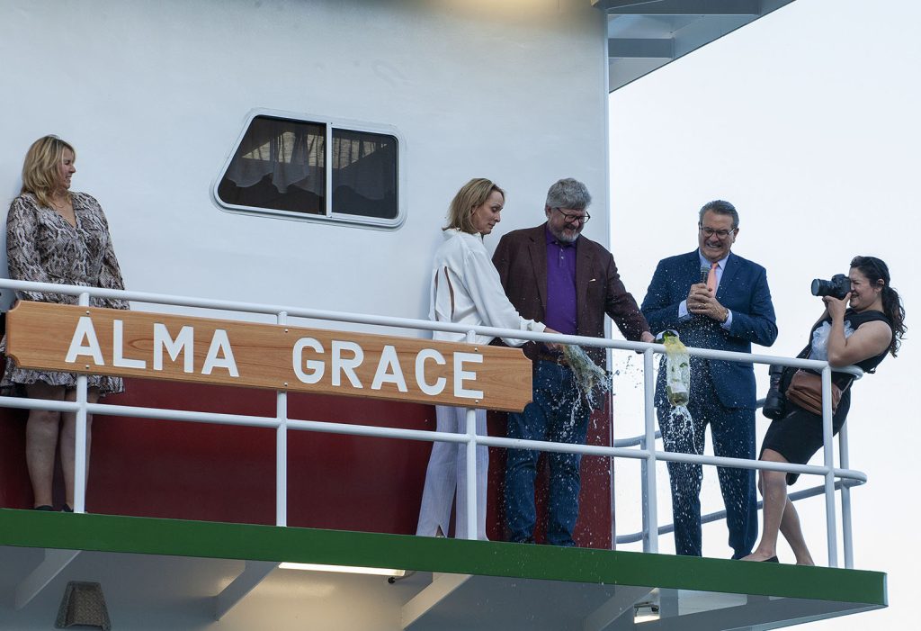 Brendan Riccobene CEO of McDonough Corporation and grandson of Alma Grace McDonough, and his wife, Shelly, break bottles of champagne to christen the mv. Alma Grace. (Photo by Frank McCormack)