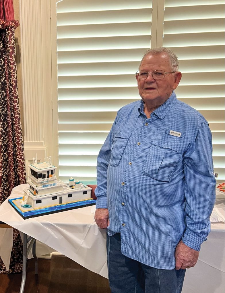 Capt. Henry Elliott celebrated his 90th birthday April 9 with a surprise party and a cake shaped like a towboat and barges. (Photo courtesy of the Elliott family)