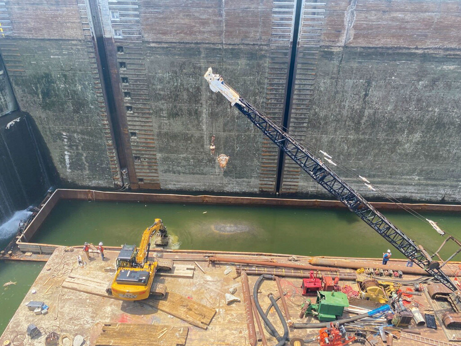 Crews work to lighter a barge loaded with rock that sank in Kentucky Lock. (Photo by Heather King, Nashville Engineer District)