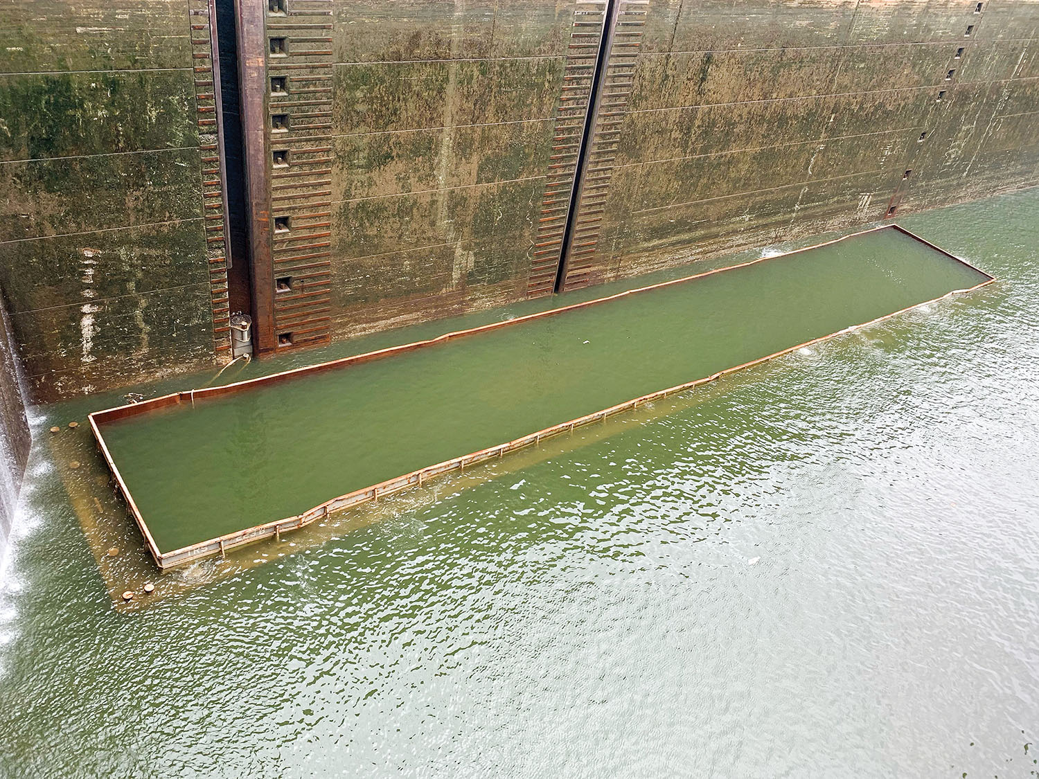 A barge carrying gravel sank June 11, 2022, in the chamber of Kentucky Lock in Grand Rivers, Ky. The Nashville Engineer District is working with Terral River Service to refloat the barge June 14. (Corps photo by Caleb Skinner)