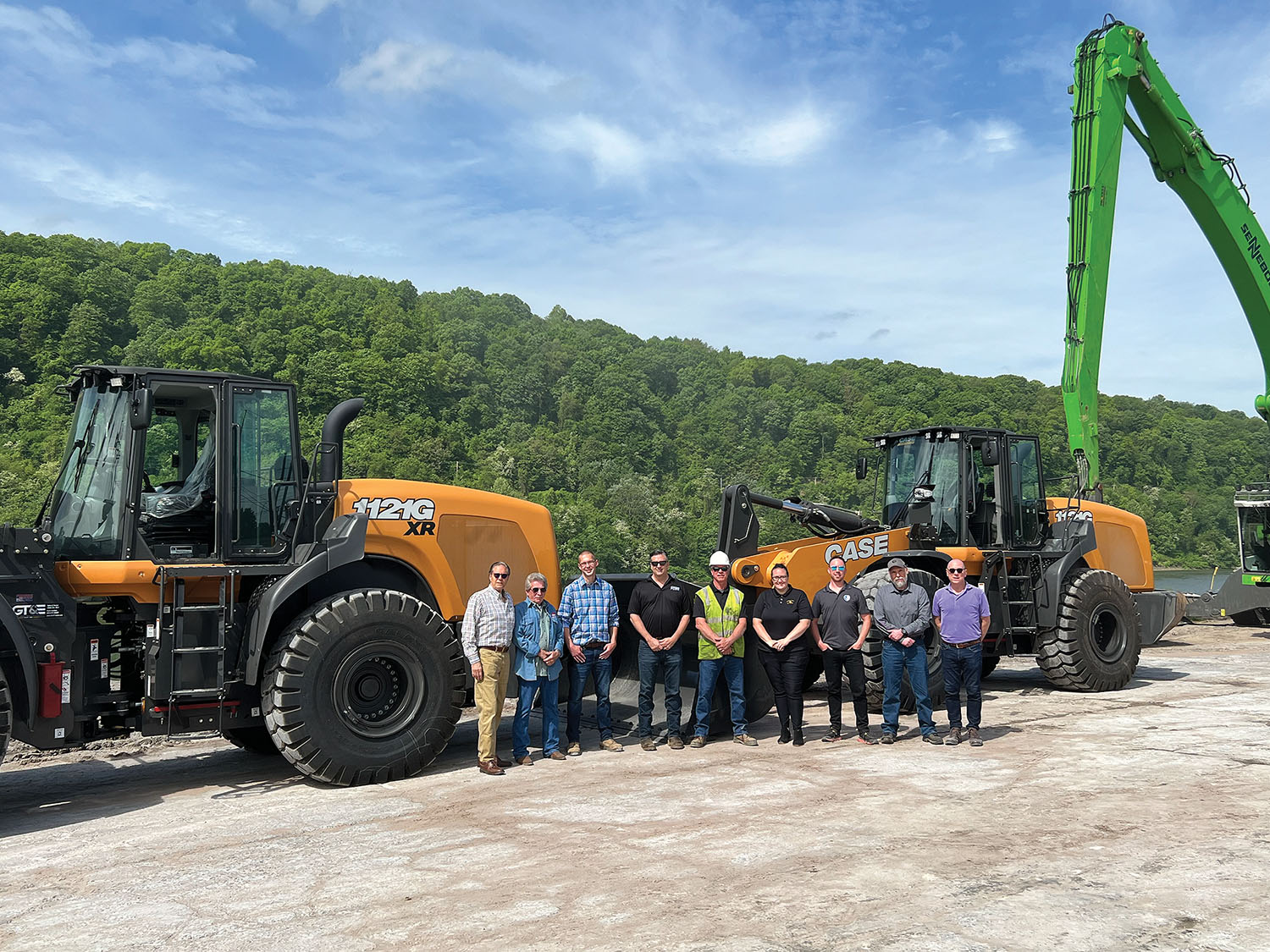 Parsons Terminal Company acquired two Case wheel loaders under the Ohio Maritime Assistance Program grant, one of three recipients located at the Columbiana County Port Authority. The port served as the pass-through for three recipients. Standing with the new equipment are (left to right) Parsons Terminal Company President Jim McClurg; Mike Milhoan, manager; Nick Sanford, territory manager for Groff Tractor; Chad Brocious, vice president for Groff Tractor; Greg Grimes, product specialist for Groff Tractor; Brittany Smith, assistant executive director for the Columbiana County Port Authority; Graham McClurg, director of sales for Parsons Terminal; Wayne Cole, manager of Seaforth Mineral; and Gary McClurg, CEO of Parsons Terminal. (Photo courtesy of the Columbiana County Port Authority)