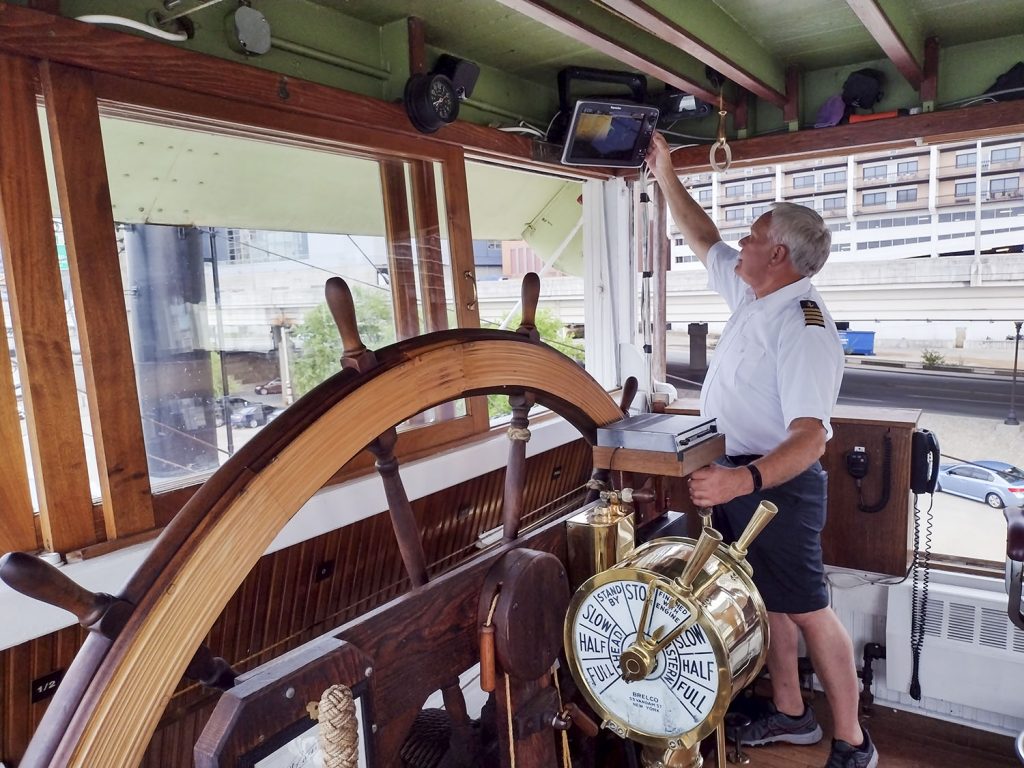 Capt. Mike Fitzgerald prepares for a sunset cruise in the pilothouse of the Belle of Louisville. (Photo by Shelley Byrne)