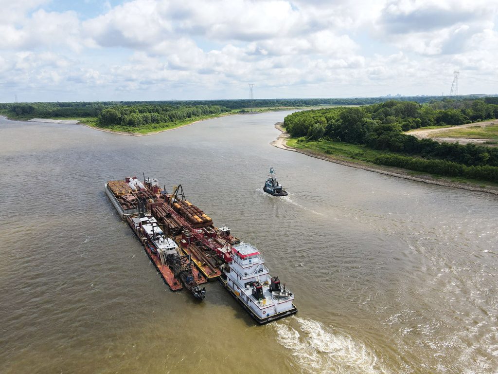 The dredge Iowa and support equipment are pushed upriver to Memphis Harbor in 2021 for the base contract for Memphis Engineer District harbor dredging. This year begins the first of two option years for the three-year contract. This year’s dredging was scheduled to begin July 1. (Photo courtesy of Great Lakes Dredge & Dock)