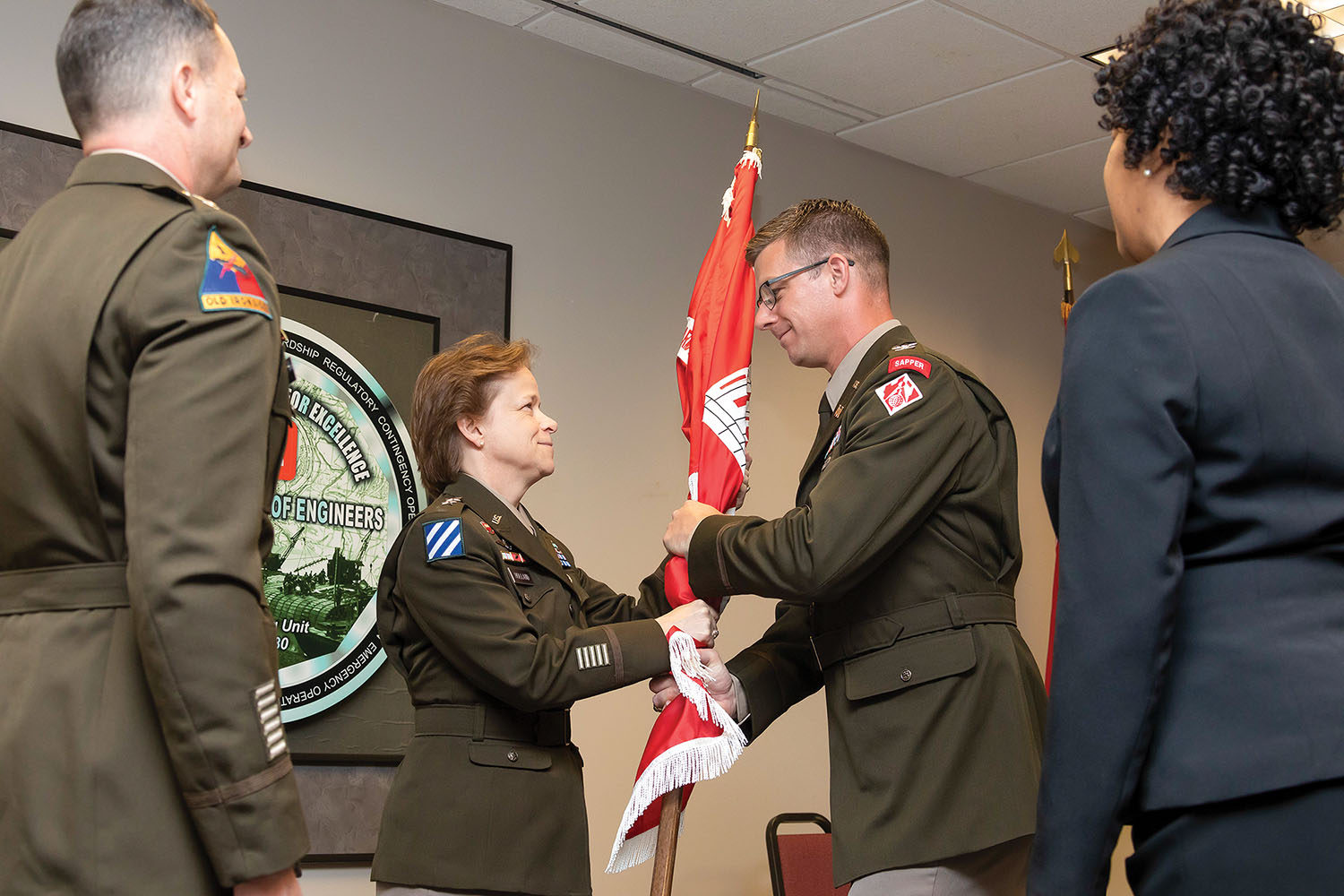 Maj. Gen. Diana Holland passes the command flag to Col. Christopher Klein as part of the Vicksburg Engineer District’s change of command ceremony. (photo courtesy of Vicksburg Engineer District)