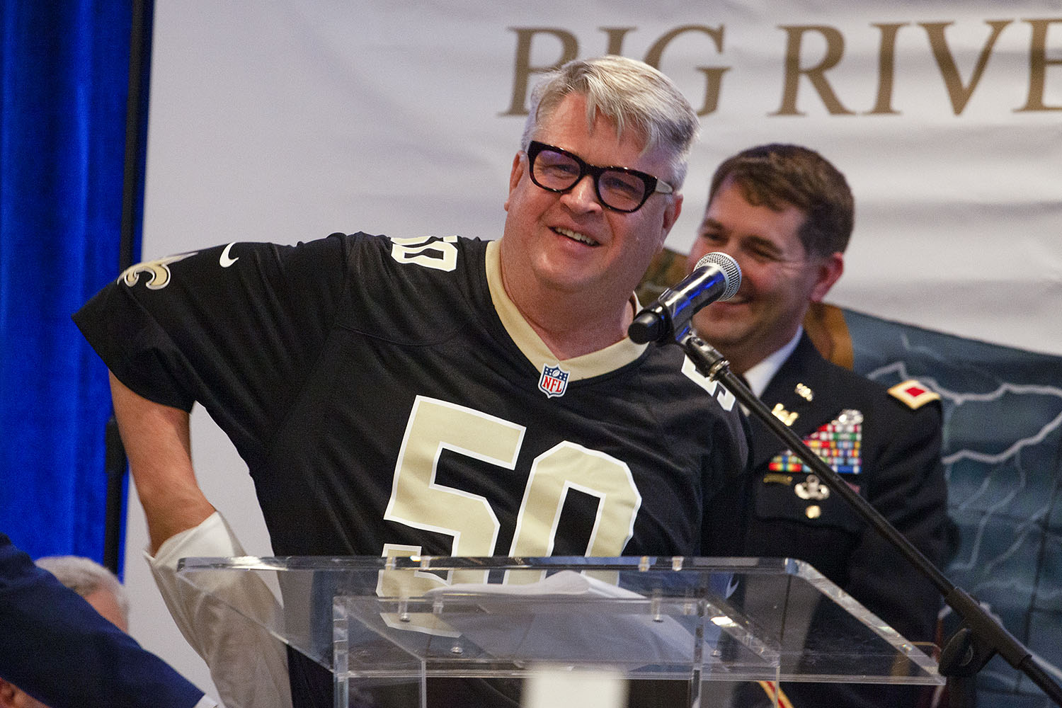 Sean Duffy, executive director of the Big River Coalition, takes off his shirt to reveal a New Orleans Saints' jersey with the number 50, signifying the newly achieved 50-foot depth for the Mississippi River Ship Channel to New Orleans. (Photo by Frank McCormack)