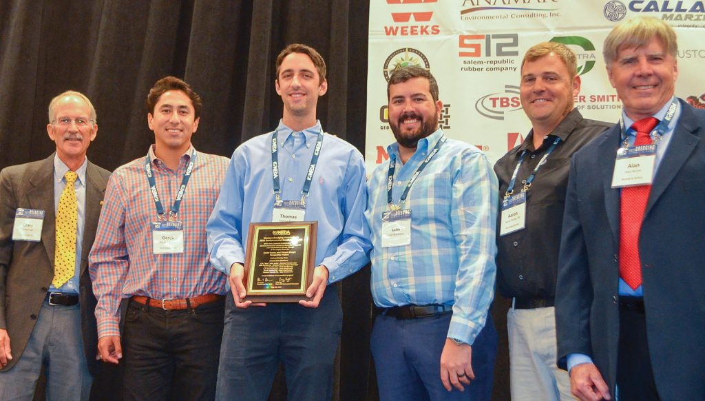 From left, Craig Vogt, team members Derek Salazar, Thomas Everett, Luis Maristany SantaMaria and Aaron Horine of Mott MacDonald, with WEDA President Alan Alcorn at the presentation of the environmental award for the project to restore Cedar Bayou and Vinson Slough Inlet on the Texas Gulf Coast. (Photo by Judith Powers)
