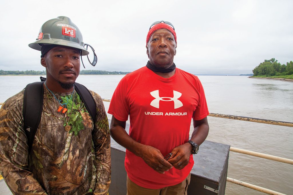 Above: Xavier Young (left) and his father, Lawrence “Fess” Young aboard the MSU quarter barge.