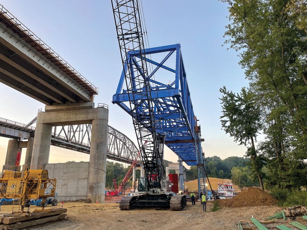 The main truss for the new U.S. 60 bridge over the Cumberland River at Smithland, Ky., rested close to 90 feet in the air on September 13 before being lowered into place on bearings atop new concrete piers. (Photo by Keith Todd/Kentucky Transportation Cabinet)