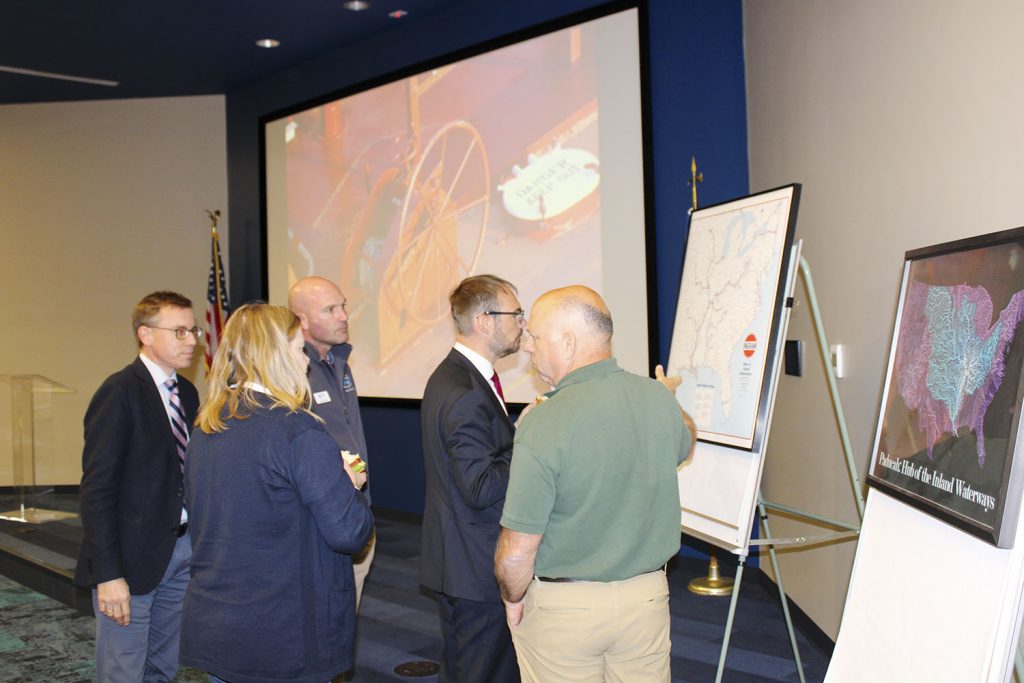 A delegation from the German Ministry of Transport gathers around maps of the U.S. inland rivers system at the Seamen’s Church Institute’s Center for Maritime Education in Paducah, Ky., during their visit. (Photo by Shelley Byrne)