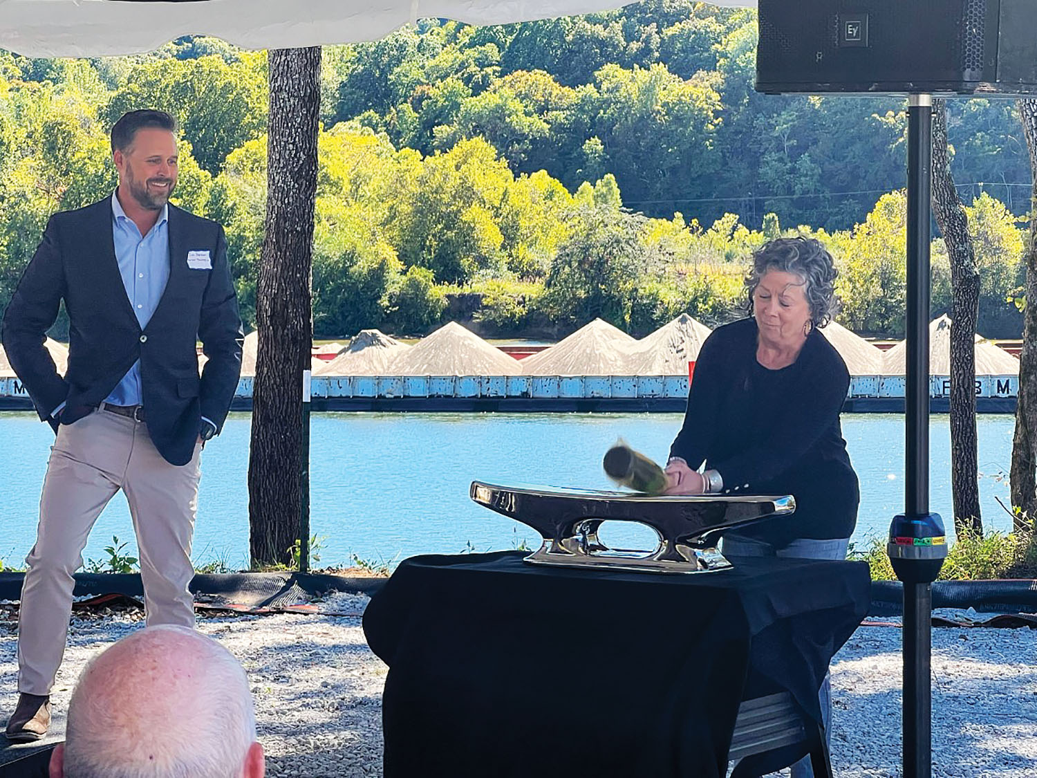 Tim Parker III, left, looks on while Tennessee State Rep. Mary Littleton breaks a bottle of champagne to ceremonially begin construction on Parker’s new Nashville Marine Terminal. (Photo courtesy of Gerald Greer)
