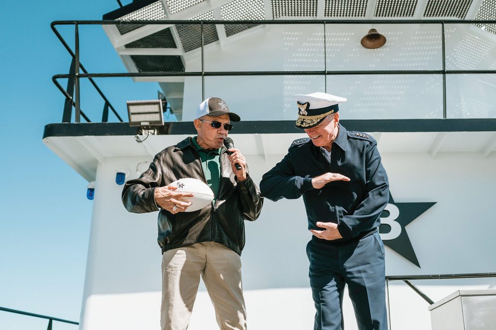 Pat Studdert hands football to Vice Commandant Steven Poulin. (Photo by Katie Sikora courtesy of Buffalo Marine)