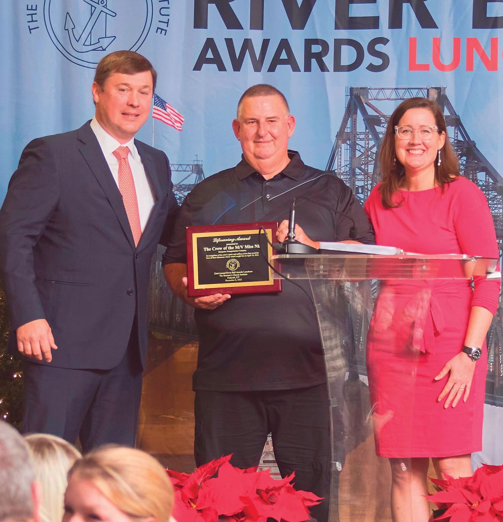 Lifesaving Award presented to the crew of the mv. Miss Niz by Damon Judd, president and CEO of Marquette Transportation Company (left) and Mary McCarthy, vice president of regulatory affairs, Turn Services (right) to Capt. James Bordelon (center), Marquette, who represented his crew who could not be in attendance: Deckhand Chris Verdin, Senior Deckhand Wendall Neal and Relief Capt. Benton Eubanks. (Photo by Brad Rankin, courtesy of Seamen's Church Institute)