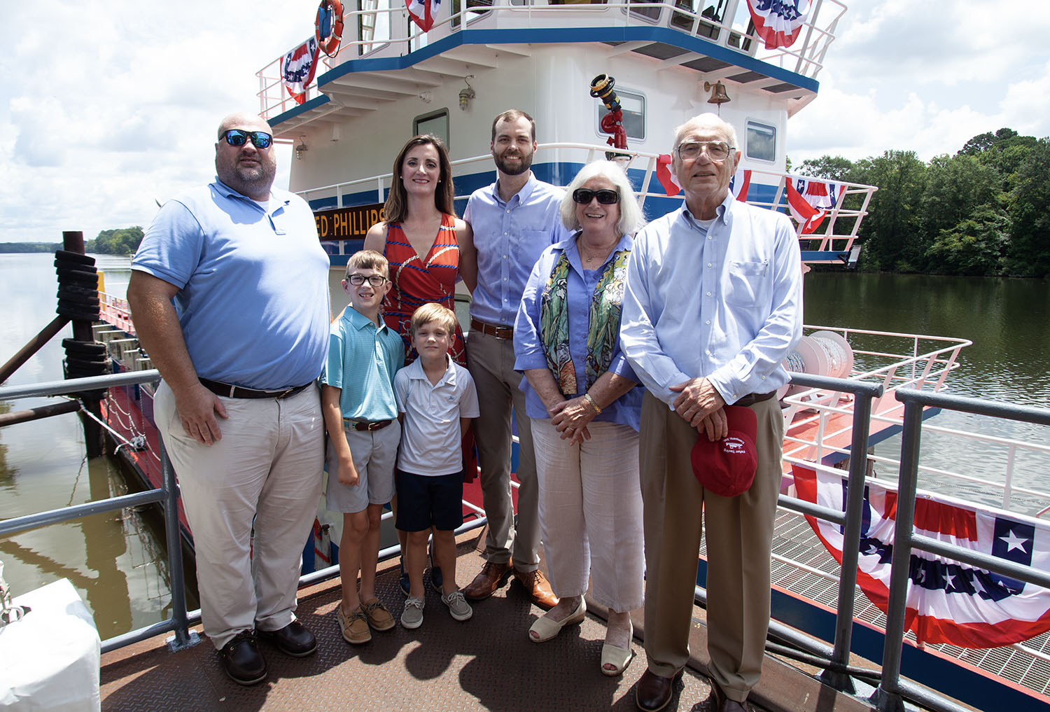 At a recent Parker Towing christening, Charlie Haun, right, stands with his family: Chas Haun (son); Alison (daughter) and Jared Phillips and their children; and wife Alice Parker Haun. (Photo by Frank McCormack)