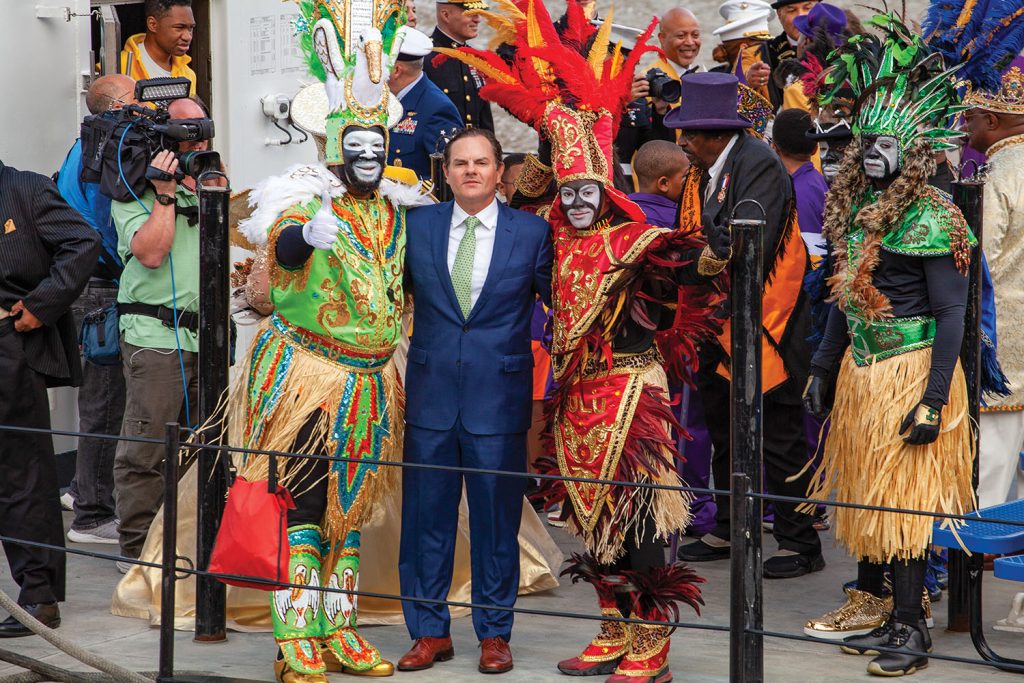 Mario Muñoz, president of New Orleans-based Turn Services, stands alongside two members of the Zulu Social Aid & Pleasure Club on February 20, Lundi Gras, aboard the U.S. Coast Guard Cutter Pamlico, a 160-foot inland construction tender. (Photo by Frank McCormack)