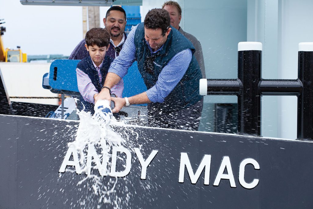 Max Macias and Austin Sperry christen the mv. Andy Mac. (Photo by Frank McCormack)