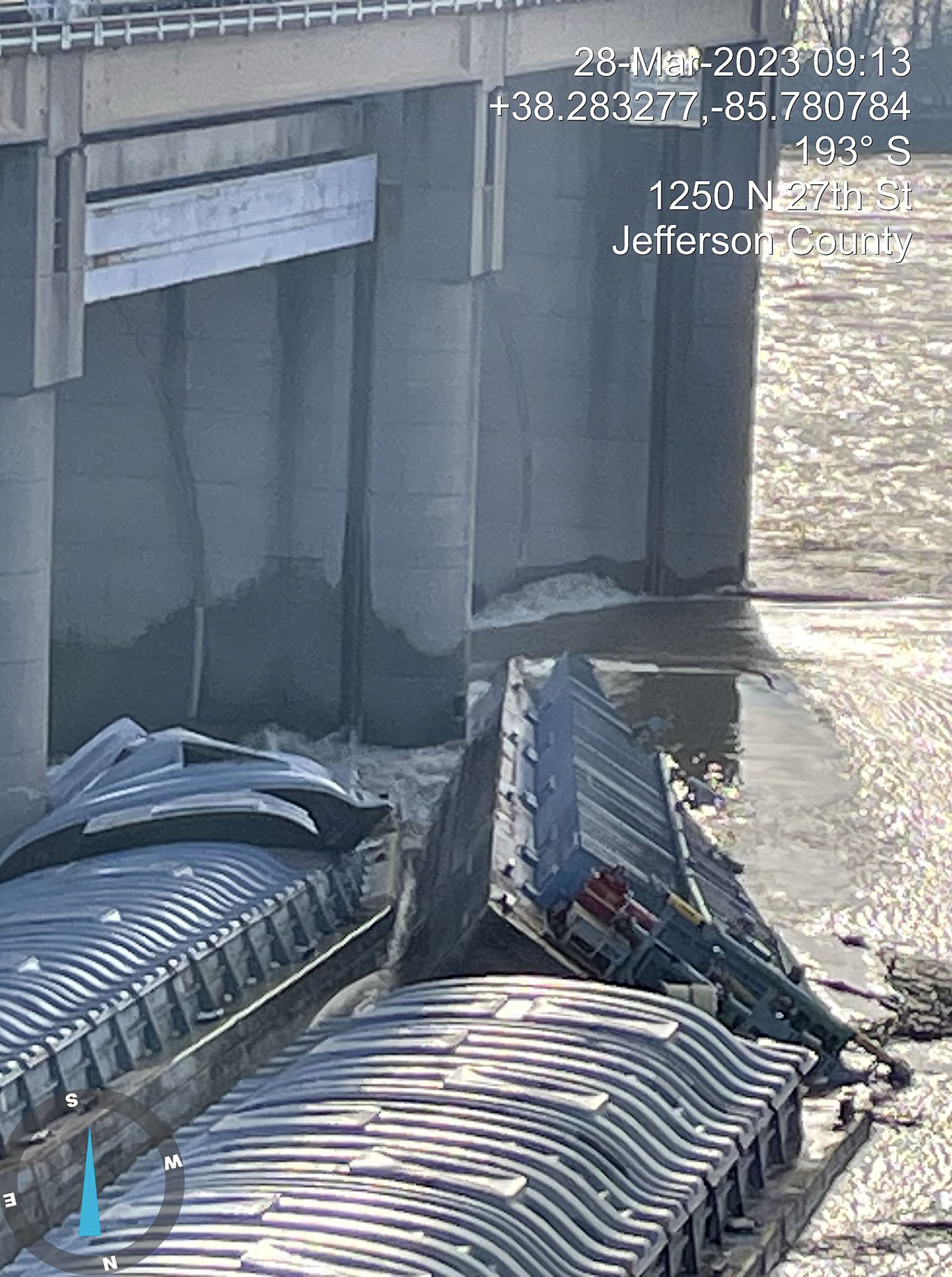 Two of three barges remain pinned against the lower dam at McAlpine Locks and Dam after breaking away from a towboat early March 28. Ten of 11 barges broke loose from a vessel, with one hitting a railroad bridge before being removed. (Photos courtesy of the Kentucky Energy and Environmental Cabinet.)