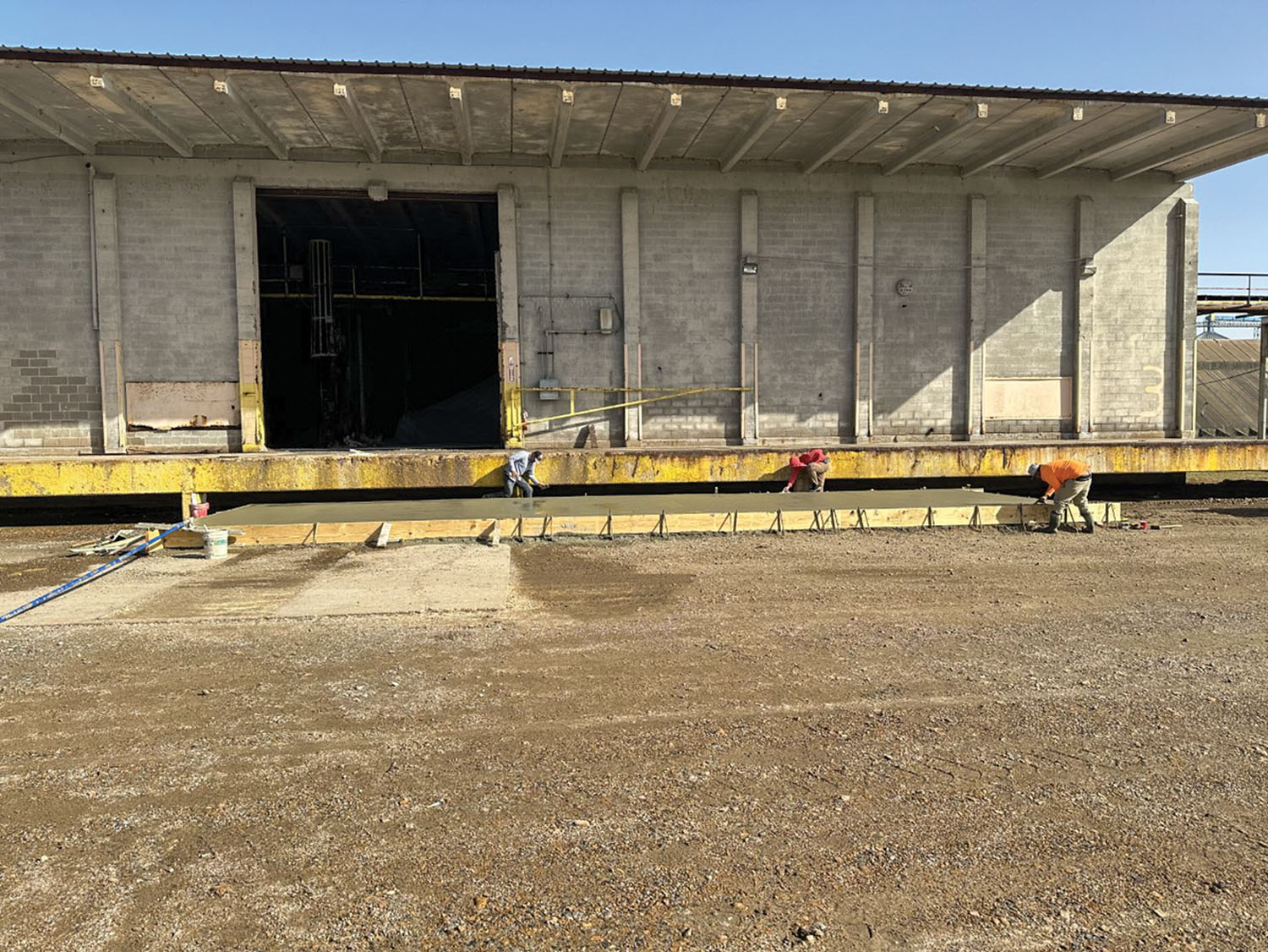 Crews pour concrete to add new fertilizer blending capabilities at the Mississippi River fertilizer and grain terminal where Scates Group Intermodal took over operations on February 27 in Helena, Ark. (Photo courtesy of Scates Group Intermodal Helena River Terminal)