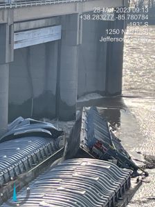 Two of three barges that initially broke away and became pinned against the lower dam at McAlpine Locks and Dam remained there March 30 after breaking away from a towboat early March 28. Ten of 11 barges broke loose from a vessel, with one hitting a railroad bridge before being removed. (Photos courtesy of the Kentucky Energy and Environmental Cabinet.)