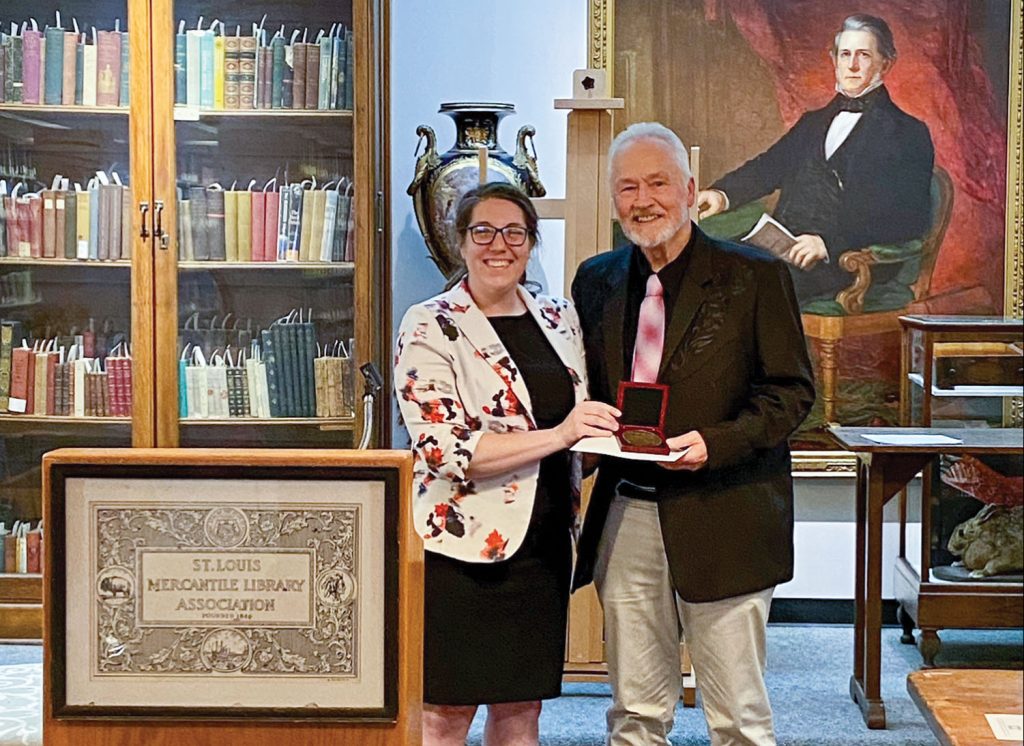 Sara Hodge, curator of the Herman T. Pott National Inland Waterways Library, presents the James V. Swift Award to Gregg Andrews. (Photo courtesy of St. Louis Mercantile Library)