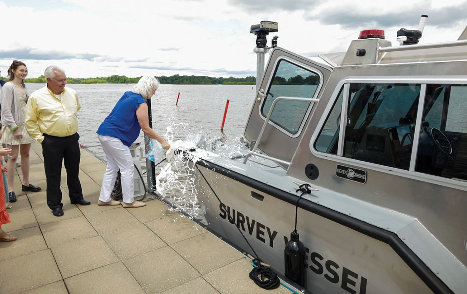 Cindy Zaiontz-DeFelice, daughter of Agnes Zaiontz, christens the new vessel on April 28. (Photo courtesy of Mobile Engineer District)