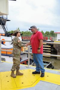 Maj. Gen. Diana Holland shakes hands with David Smith, lockmaster at Algiers Lock. (Photo courtesy of Corps of Engineers)