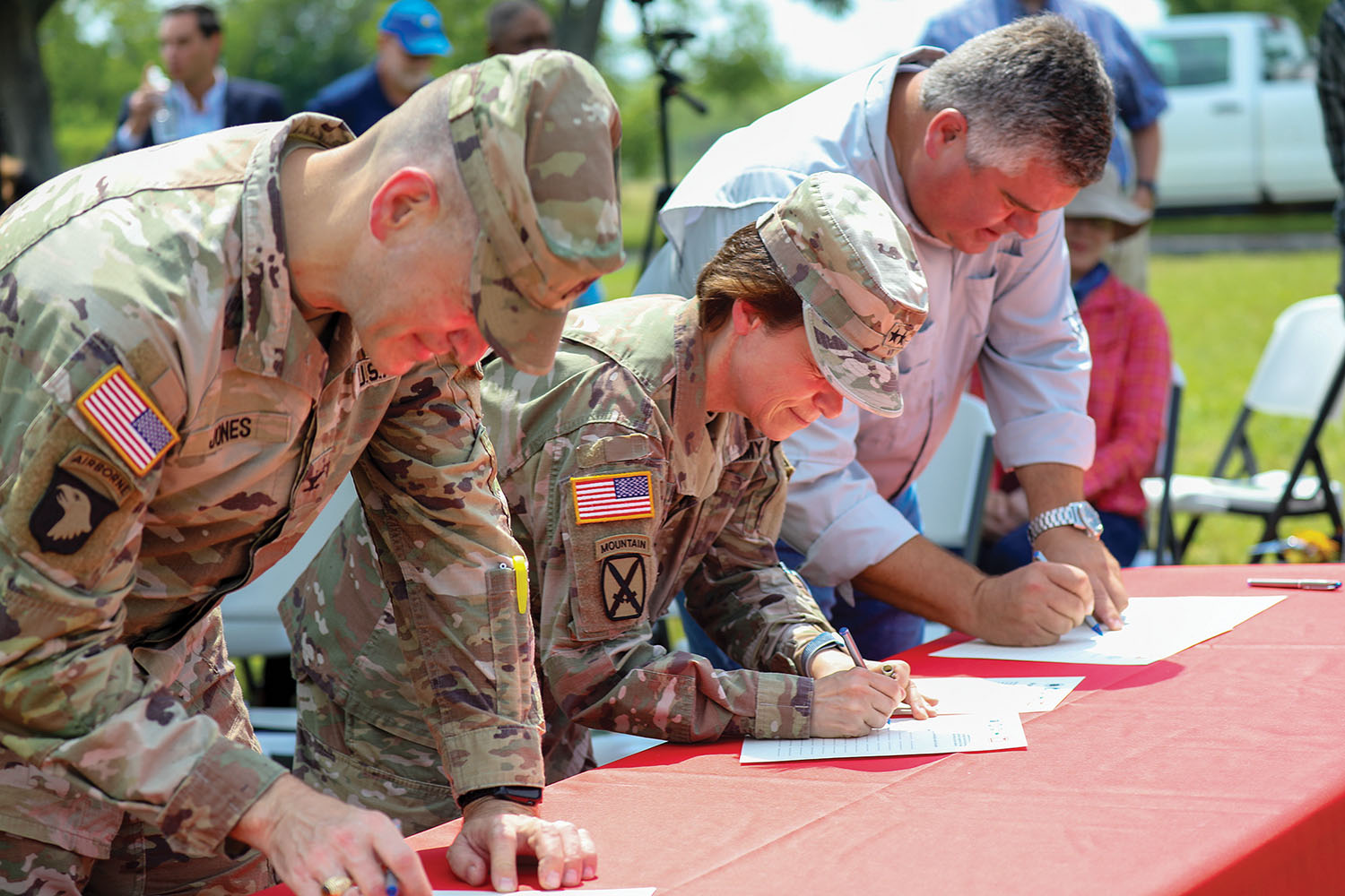 From left, Col. Cullen Jones, Maj. Gen. Diana Holland, and Ben Haase sign partnership agreement. (Photo courtesy of Corps of Engineers)