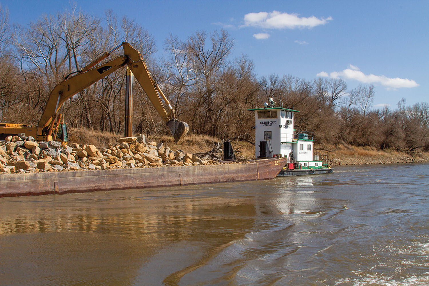 W.A. Ellis Construction Company contractors work to make repairs to river training structures on the Missouri River on a floating barge near Atchison, Kansas, on April 5, 2023. (Photo by Jessica Schaeffer, Kansas City Engineer District)