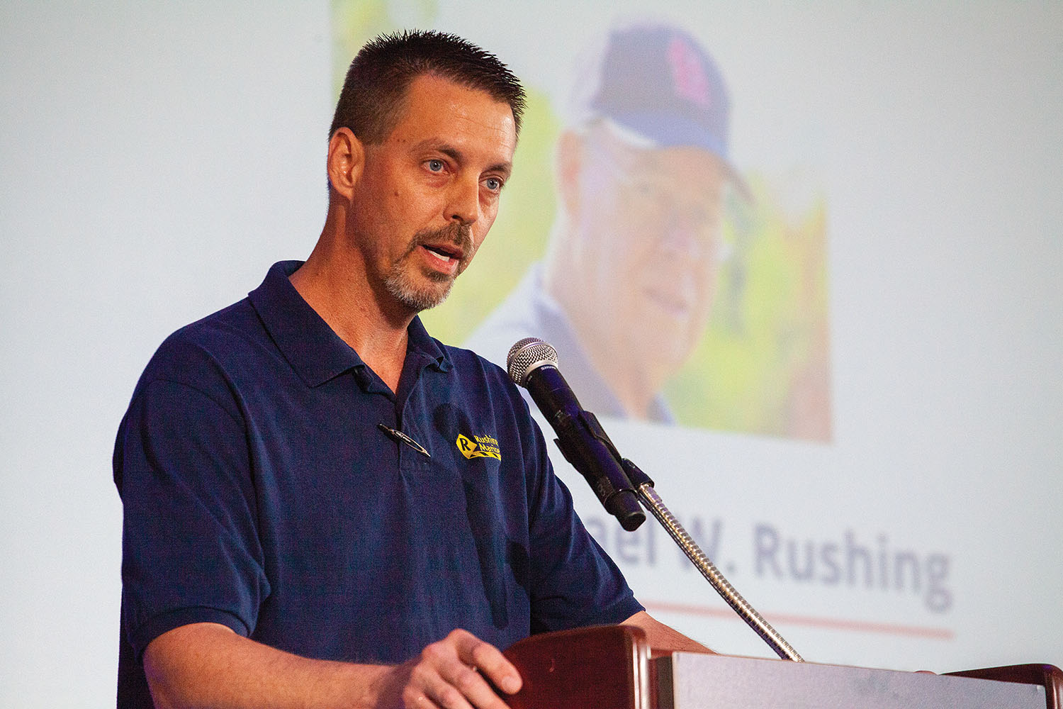 Todd Rushing speaks during ceremony honoring his father, the late Michael Rushing, at the Inland Marine Expo. (Photo by Frank McCormack)