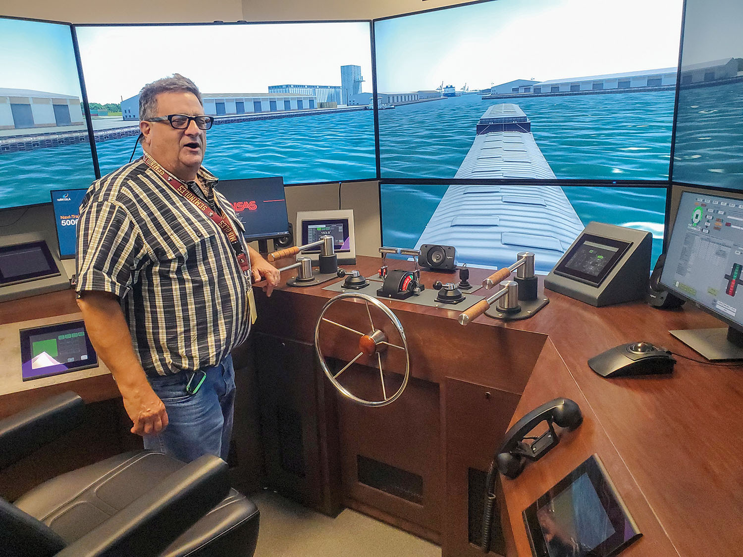Capt. Randy Savoie demonstrates the use of rudder sticks during a simulated transit of the upper Houston Ship Channel, using a Transas computer simulator at Northshore Technical Community College. (photo by Capt. Richard Eberhardt)