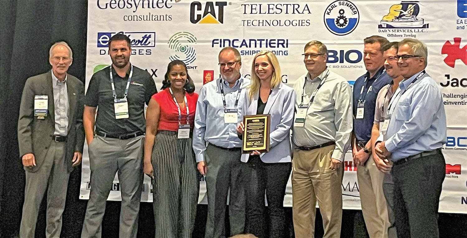 Partners in the Spirit Lake remediation project at the awards ceremony, where the project received the award for excelling in Partnerships and Outreach/Education. They are, from left, Craig Vogt, chair, WEDA Environmental Commission; Dustin Bauman, J.F. Brennan; Ashley J. Bell, Illinois-Indiana Sea Grant/University of Illinois Extension; Mark Rupnow, US Steel;  Courtney Pacelli, EA Engineering, Science, and Technology Inc., PBC (Public Benefit Company); Jeff Boltz, EA Engineering; Jamie Bankston, EA Engineering; Jamie Beaver, EA Engineering; and Mike Ciarlo, EA Engineering.