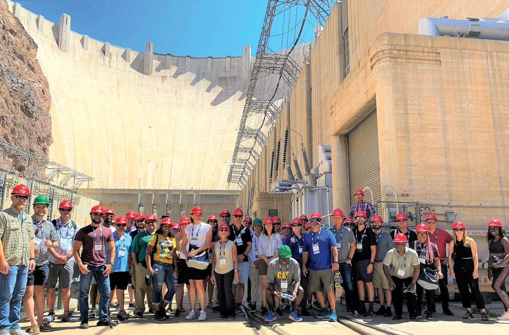 Attendees gather at the base of the Hoover Dam following a tour of the massive hydropower equipment inside the dam.  (Photo by Judith Powers)