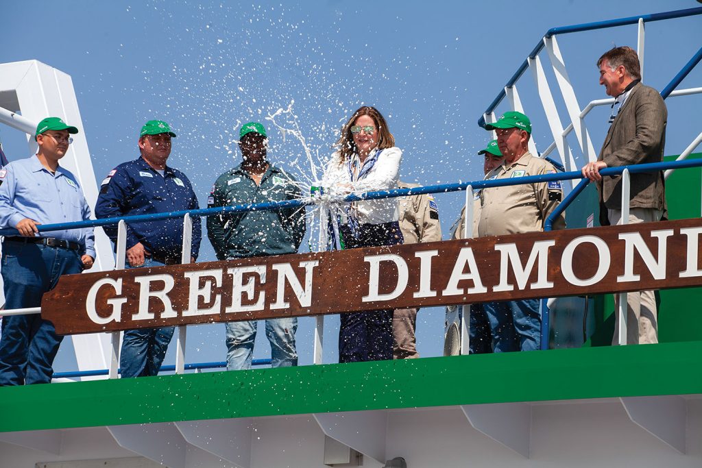 Taylor Dickerson, vice president of Kirby Inland Marine’s management office and the company’s ESG leader, christens the mv. Green Diamond to cap off the the August 25 ceremony. (Photo by Frank McCormack)