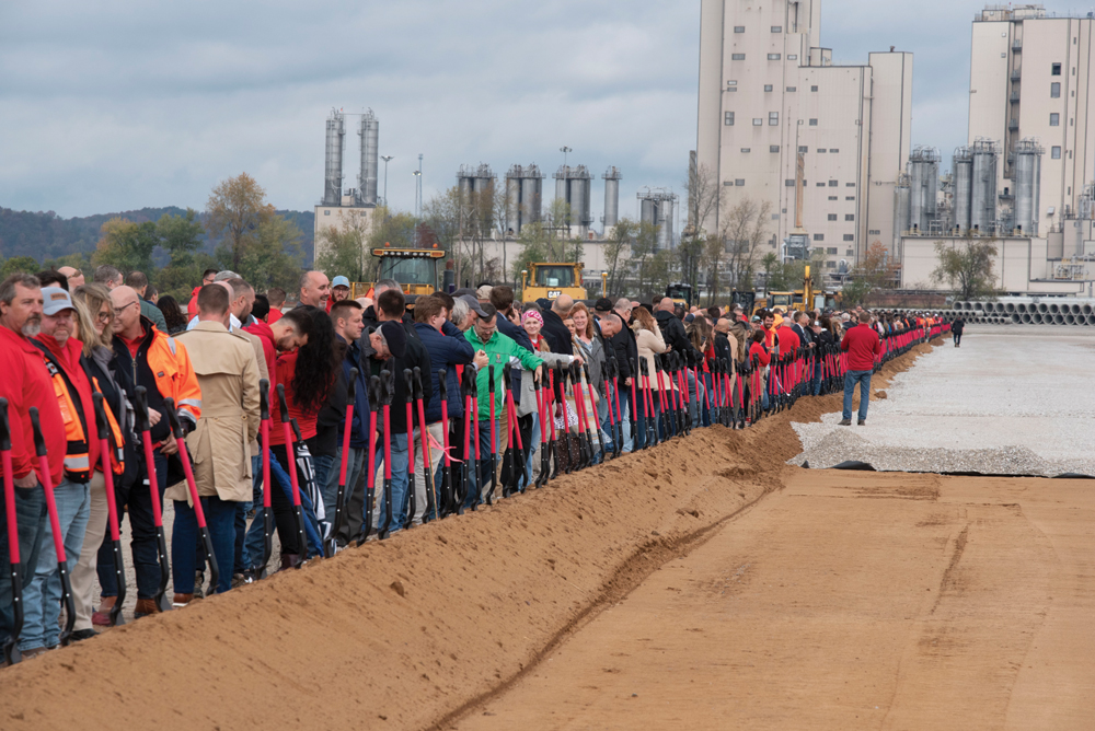 Those attending the groundbreaking ceremony for Nucor Steel West Virginia line up to turn 550 shovels of dirt at the same time, breaking a world record as documented by Guinness World Records, which had staff on site to verify the record for the world’s longest shovel line. It stretched nearly half a mile. (photo by Jim Ross)