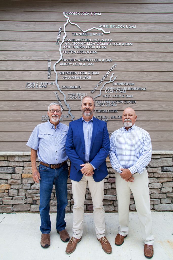 Justin Murphree (middle), the current operations project manager for the Tennessee-Tombigbee Waterway stands outside the new Waterway Management Center with his two predecessors, Al Wise (left), who served from 1999 to 2006, and Rick Saucer, who served from 2006 to 2018. (Photo by Frank McCormack)