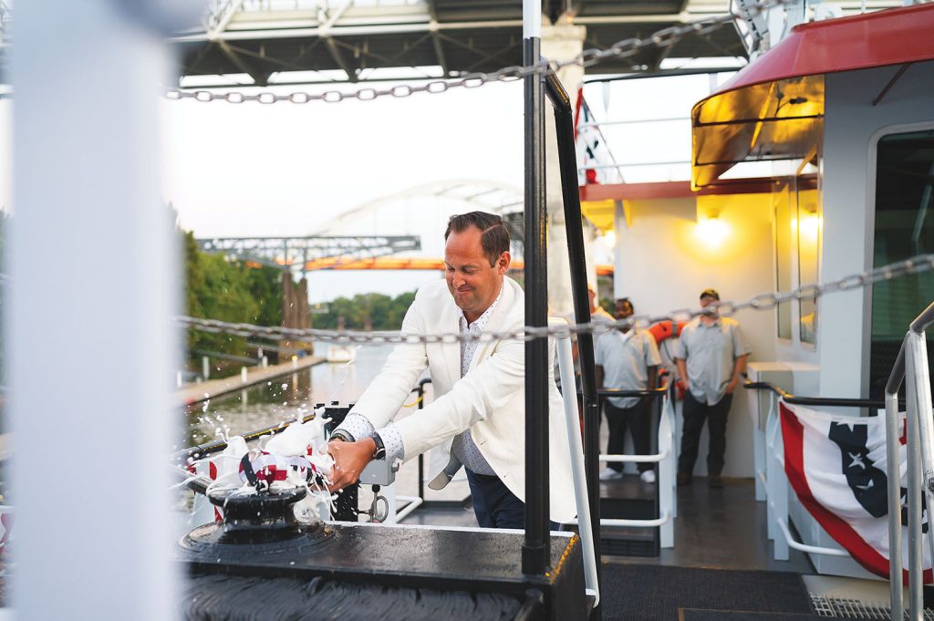 Chris Mills christens his namesake towboat. (Photo courtesy of Hines Furlong Line)