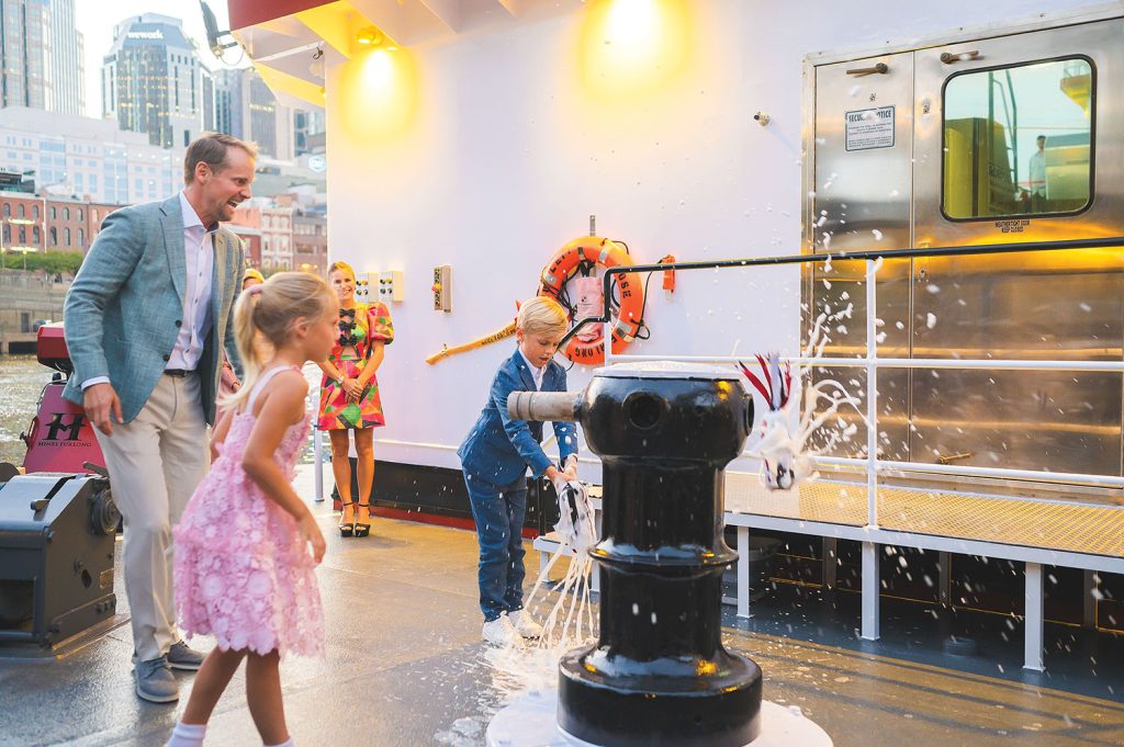 Kent Furlong watches as Scarlett and Porter Furlong christen the Scarlett Rose Furlong. (Photo courtesy of Hines Furlong Line)