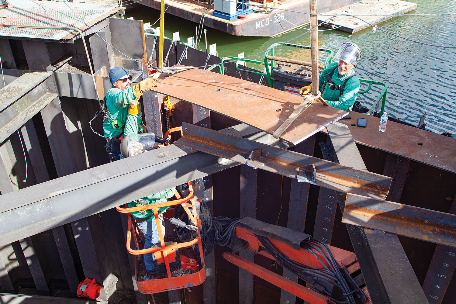 Crews working to repair a damaged sector gate at Algiers Lock, which was damaged in a July 4 allision. (Photos by Frank McCormack)