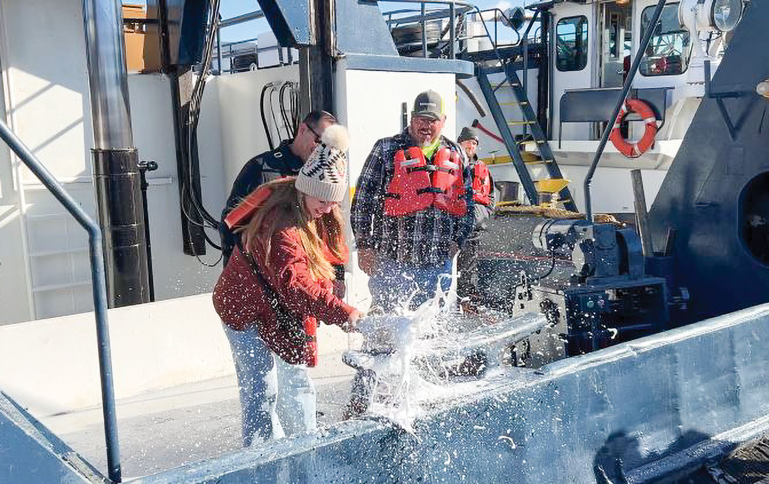 Macey Lauren Ozinga christens her namesake vessel. (Photo courtesy of Middle River Marine)