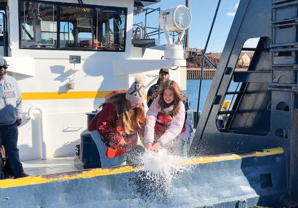 Macey and Ava Ozinga jointly christen the mv. Carmalee Rose. (Photo courtesy of Middle River Marine)