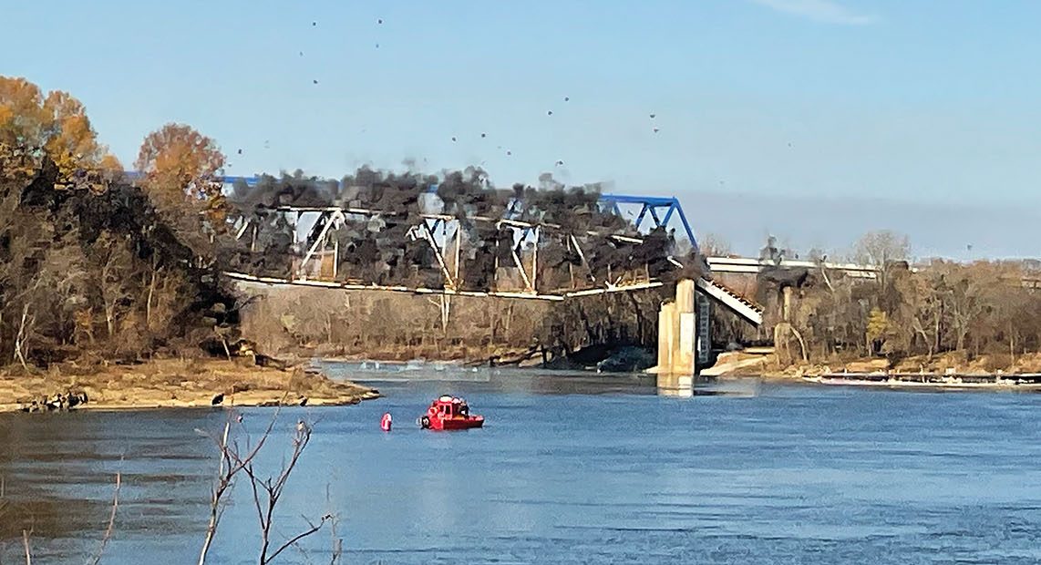 Explosive charges take down the 1931 Old U.S. 60 Cumberland River Bridge at Smithland, Ky., on November 30. Traffic moved to the new, blue bridge alongside it in May. (photo by Keith Todd/Kentucky Department of Highways)