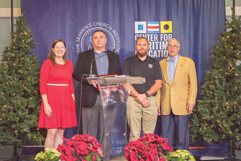 Mary McCarthy, Moran Towing director of sustainability and corporate responsibility, with Amherst Madison River Bell Lifesaving Award winners, from left: Capt. Adam Adkins and Lane Rhoades, mate; with Bill Barr, Amherst Madison vice president for safety and compliance. (Photo courtesy of Seamen's Church Institute)