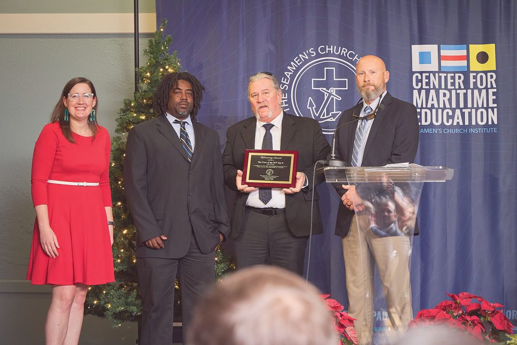 Mary McCarthy, Moran Towing director of sustainability and corporate responsibility, with Parker Towing River Bell Lifesaving Award winners, from left: Darius Thomas, deckhand; Nick Verdugo, relief captain; and Chris Eberlein, port captain. (Photo courtesy of Seamen's Church Institute)