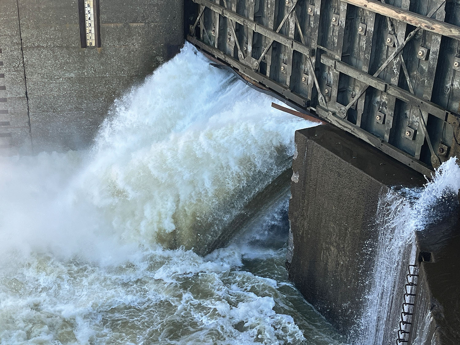 Water rushes under the upper miter gate of Demopolis Lock following a breach of the gate sill January 16. (U.S. Army photo by Ryan Reich)